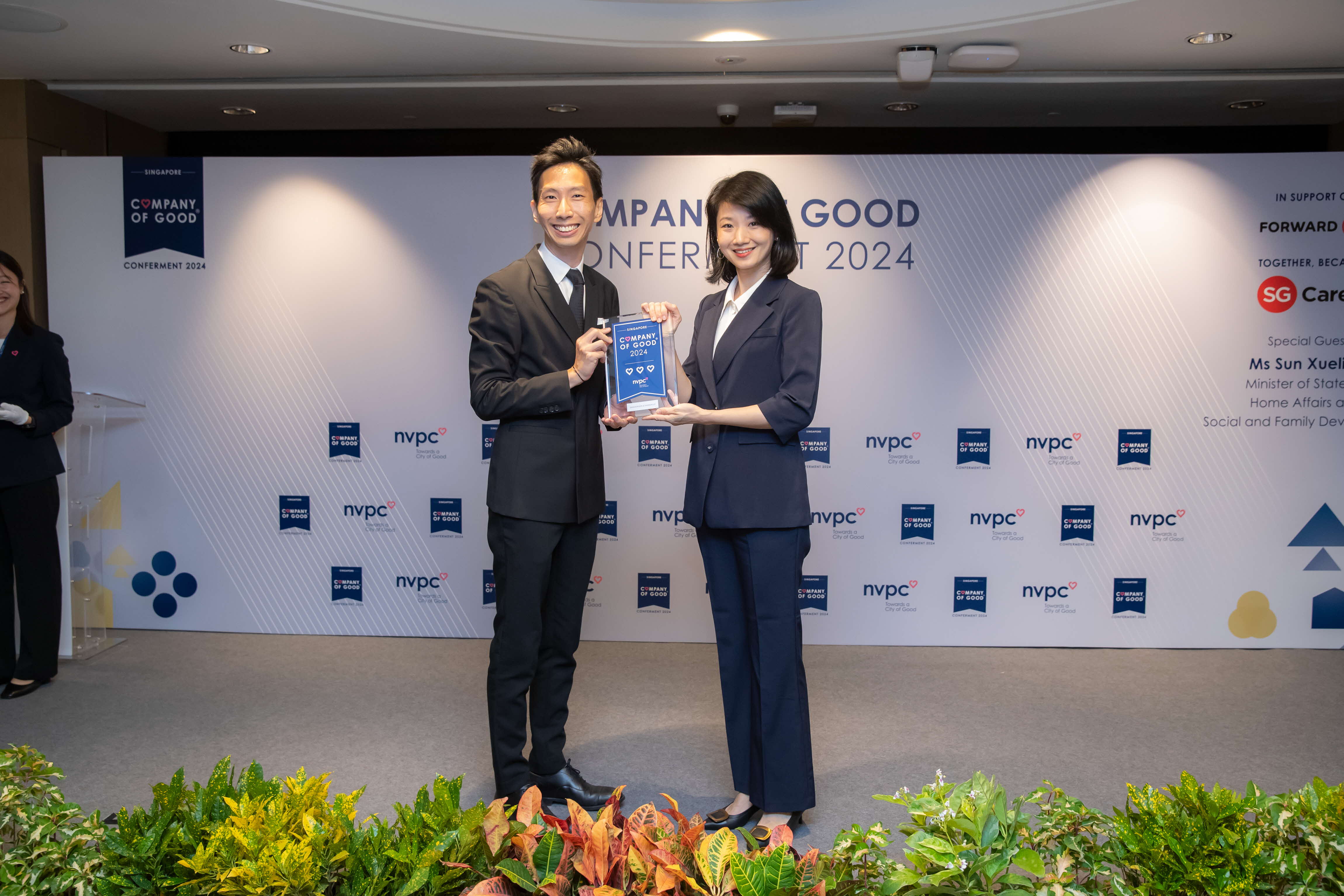 Partner Terence Wong receiving the conferment award from Sun Xueling, Minister for Social and Family Development of Singapore