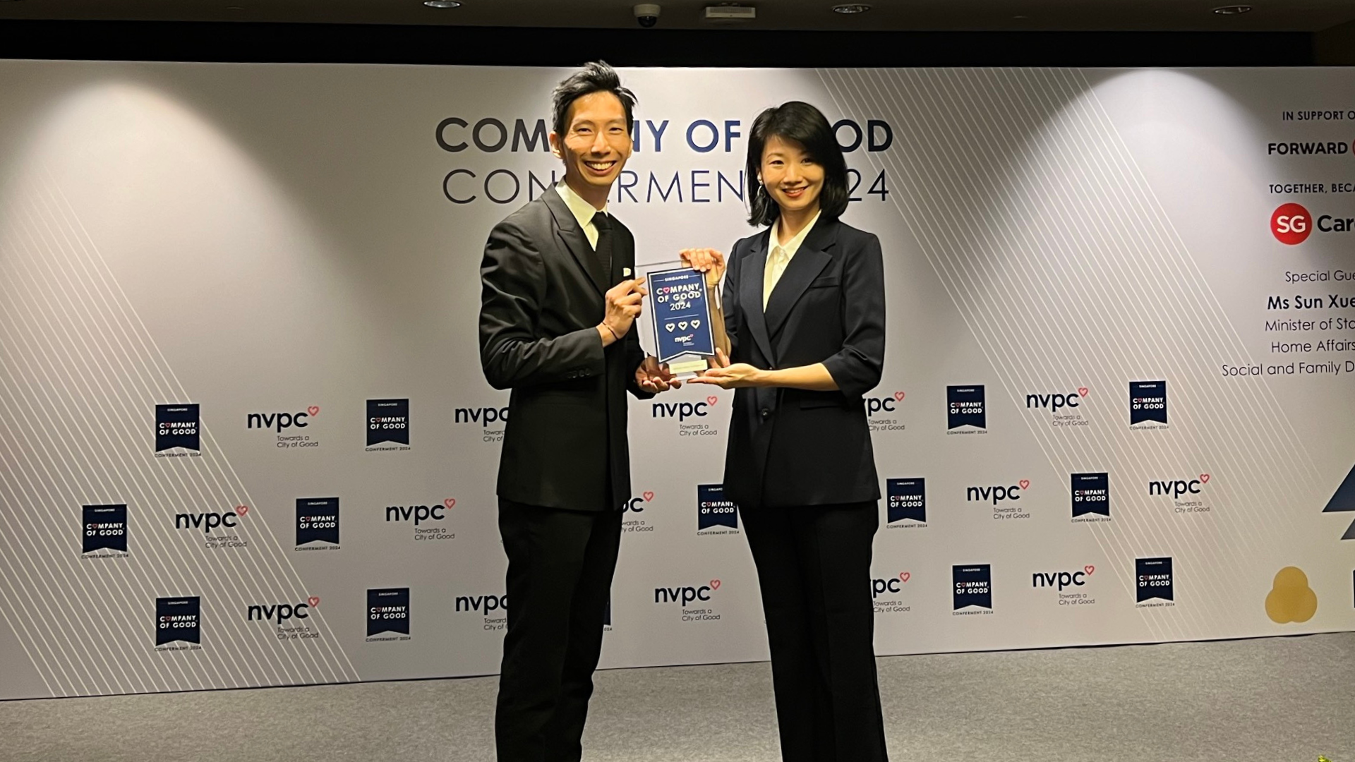 Partner Terence Wong receiving the conferment award from Sun Xueling, Minister for Social and Family Development of Singapore