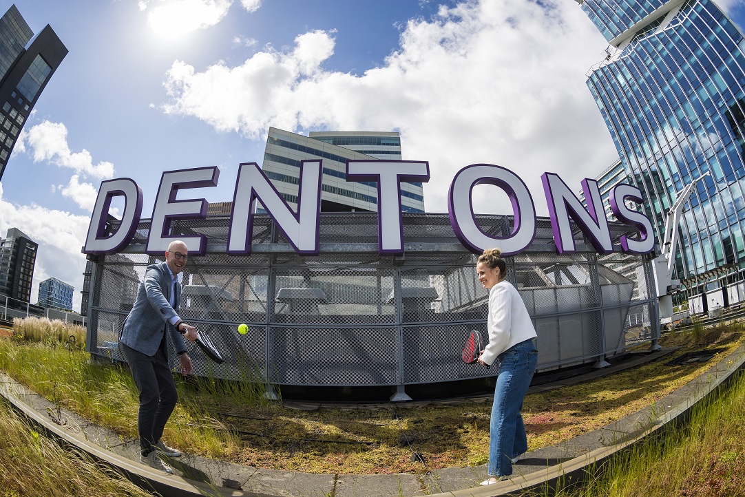 Marc Kuijper (Dentons Netherlands Managing Partner) and Fatima Moreira de Melo (Tournament Director Decathlon Premier Padel Rotterdam) kick off the Official Partnership with a game of padel on the roof of the Dentons office in Amsterdam